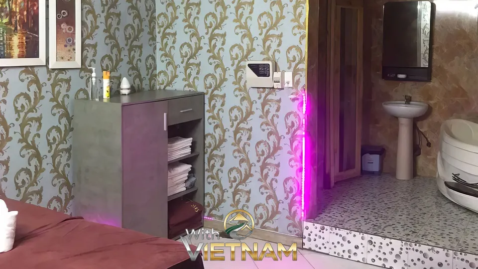 마사지 베드와 분홍색 조명의 욕실